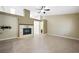 Spacious living room with a fireplace, ceiling fan, and tile flooring throughout at 8541 Highland View Ave, Las Vegas, NV 89145