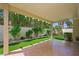 View of the backyard patio with tiled flooring and a manicured yard and lush greenery at 8541 Highland View Ave, Las Vegas, NV 89145