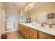 Bright bathroom boasts double sinks, wood cabinets, and a glass-enclosed shower at , Henderson, NV 89044