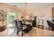 Inviting dining area with chandelier lighting, dark wood furniture, and sliding glass doors to patio at , Henderson, NV 89044