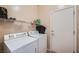 Functional laundry room with modern washer and dryer, and convenient shelving at , Henderson, NV 89044