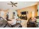 Cozy living room with comfortable leather sofas, ceiling fan, recessed lighting, and stylish decor at , Henderson, NV 89044