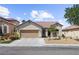 Charming single-story home featuring desert landscaping, a two-car garage, and a classic tile roof at 1006 Cove Palisades Dr, North Las Vegas, NV 89031