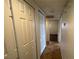 Hallway view with storage closets and tile flooring leading to bedroom at 101 Luna Way # 145, Las Vegas, NV 89145