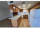 Bright kitchen featuring an island and white appliances, plus tile flooring at 101 Luna Way # 145, Las Vegas, NV 89145