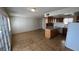 View of the open living room leading into the kitchen featuring neutral paint and tile floors at 101 Luna Way # 145, Las Vegas, NV 89145