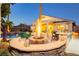Stunning backyard featuring a fire pit, outdoor kitchen, pool, and covered patio for ultimate relaxation at 10243 Cowboys Dream St, Las Vegas, NV 89131