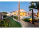 Beautiful backyard with a pool, spa, putting green, covered patio, and lush landscaping perfect for outdoor living at 10243 Cowboys Dream St, Las Vegas, NV 89131