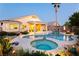 Resort-style backyard with a sparkling pool, spa, lush landscaping, and a covered patio for outdoor living at 10243 Cowboys Dream St, Las Vegas, NV 89131
