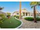Backyard with a putting green, mature landscaping, and a covered patio area at 10243 Cowboys Dream St, Las Vegas, NV 89131