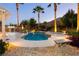 Luxurious pool area with a spa, lush landscaping, stone benches, and a pergola offering a serene outdoor retreat at 10243 Cowboys Dream St, Las Vegas, NV 89131