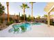 Stunning backyard featuring a freeform pool, spa, mature landscaping, and a pergola at 10243 Cowboys Dream St, Las Vegas, NV 89131