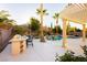 Resort-style backyard oasis with pool, spa, swim-up bar, fire pit, mature trees and pergola at 10243 Cowboys Dream St, Las Vegas, NV 89131