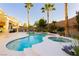 Backyard view of in-ground pool and spa with swim-up bar, fire pit, and mature landscaping at 10243 Cowboys Dream St, Las Vegas, NV 89131