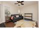 This bedroom features a ceiling fan, window blinds, and wooden floors at 10243 Cowboys Dream St, Las Vegas, NV 89131