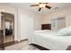 This bedroom features a ceiling fan, window blinds, and hardwood floors at 10243 Cowboys Dream St, Las Vegas, NV 89131
