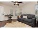 This bedroom features a ceiling fan, window blinds, and wooden floors at 10243 Cowboys Dream St, Las Vegas, NV 89131