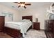 This elegant bedroom features dark wood furniture, and a soft area rug at 10243 Cowboys Dream St, Las Vegas, NV 89131
