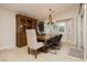 The dining area is brightly lit with a wooden dining table and decorative chandelier at 10243 Cowboys Dream St, Las Vegas, NV 89131