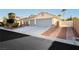 A well maintained single-story home features a three car garage and desert landscaping at 10243 Cowboys Dream St, Las Vegas, NV 89131