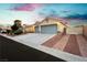 Well-maintained home featuring a spacious driveway, desert landscaping, and a convenient side gate for added privacy at 10243 Cowboys Dream St, Las Vegas, NV 89131