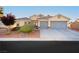 Charming single-story home featuring a well-maintained yard, desert landscaping, and a two-car garage at 10243 Cowboys Dream St, Las Vegas, NV 89131