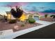 Beautifully landscaped front yard with desert landscaping, a well-manicured lawn, and a two-car garage at 10243 Cowboys Dream St, Las Vegas, NV 89131
