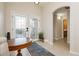 Elegant foyer featuring tiled flooring, a decorative glass door, and arched entryway leading to other areas of the home at 10243 Cowboys Dream St, Las Vegas, NV 89131