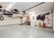 Large garage with overhead storage, epoxy floors, ample shelving, and space for vehicles at 10243 Cowboys Dream St, Las Vegas, NV 89131