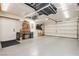 A large garage with an epoxy floor, storage racks, a freezer, and a workbench with boxes at 10243 Cowboys Dream St, Las Vegas, NV 89131