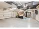 Spacious garage with epoxy flooring, overhead storage racks, and ample room for vehicles and storage at 10243 Cowboys Dream St, Las Vegas, NV 89131