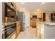 This kitchen is equipped with granite countertops, wooden cabinets, and stainless steel appliances at 10243 Cowboys Dream St, Las Vegas, NV 89131