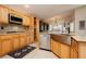 The kitchen features an undermount sink, granite countertops, wooden cabinets, and stainless steel appliances at 10243 Cowboys Dream St, Las Vegas, NV 89131