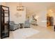 Spacious living room with tile flooring, high ceilings, and modern decor, seamlessly connecting to the kitchen area at 10243 Cowboys Dream St, Las Vegas, NV 89131