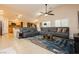 Spacious living room with a modern ceiling fan, beautiful rug, and comfortable gray couch at 10243 Cowboys Dream St, Las Vegas, NV 89131