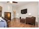 This main bedroom features wood floors and a comfortable sitting area with modern furniture at 10243 Cowboys Dream St, Las Vegas, NV 89131