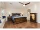 Cozy main bedroom with hardwood floors, wooden furniture, and a bench under the window at 10243 Cowboys Dream St, Las Vegas, NV 89131