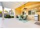 Inviting covered patio with a ceiling fan, dining set, and stainless mini fridge perfect for entertaining at 10243 Cowboys Dream St, Las Vegas, NV 89131