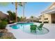 Private backyard oasis featuring a sparkling pool, lush landscaping, and a covered patio at 10243 Cowboys Dream St, Las Vegas, NV 89131