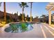 Relaxing pool and spa area with inset chairs, beautiful landscaping, and a covered patio for ultimate outdoor enjoyment at 10243 Cowboys Dream St, Las Vegas, NV 89131