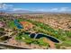 Stunning aerial view of the community, showcasing lush golf courses, serene water features, and mountain views at 10636 Argents Hill Dr, Las Vegas, NV 89134