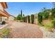 Gravel backyard featuring a fountain and trimmed hedges and trees at 10636 Argents Hill Dr, Las Vegas, NV 89134
