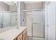 Well-lit bathroom featuring single sink vanity with a glass door shower at 10636 Argents Hill Dr, Las Vegas, NV 89134