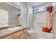 Bright bathroom featuring a shower-tub combo and a wooden vanity at 10636 Argents Hill Dr, Las Vegas, NV 89134