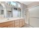 Bright bathroom with dual sinks, framed mirrors, and glass shower at 10636 Argents Hill Dr, Las Vegas, NV 89134