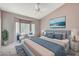 Staged bedroom featuring a ceiling fan, a bay window and neutral walls and carpet at 10636 Argents Hill Dr, Las Vegas, NV 89134