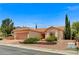 Attractive single-story house showcasing desert landscaping, a tile roof, and an attached two-car garage at 10636 Argents Hill Dr, Las Vegas, NV 89134