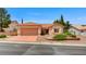 Charming one-story home features a terra cotta roof, desert landscaping, and a two-car garage at 10636 Argents Hill Dr, Las Vegas, NV 89134