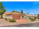 Inviting home features desert landscaping, terra cotta roof, and a two-car garage at 10636 Argents Hill Dr, Las Vegas, NV 89134