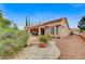 Back of the home with a covered patio and desert landscaping at 10636 Argents Hill Dr, Las Vegas, NV 89134